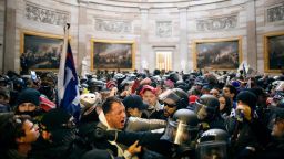 Police clash with supporters of US President Donald Trump who breached security and entered the Capitol building in Washington DC on January 6, 2021.