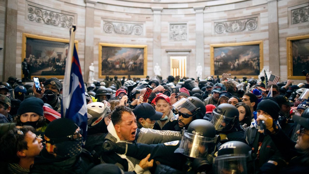 Police clash with supporters of US President Donald Trump who breached security and entered the Capitol building in Washington DC on January 6, 2021.