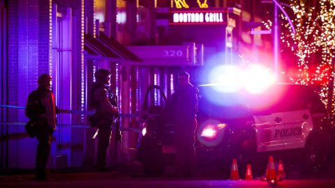 Police stand outside a Lakewood, Colorado, shopping center where the suspected gunman was killed.