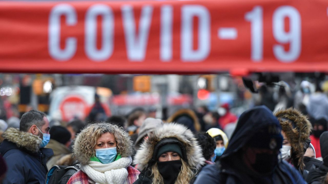 People wait in line for Covid-19 tests Monday at a mobile testing site in New York's Times Square.
