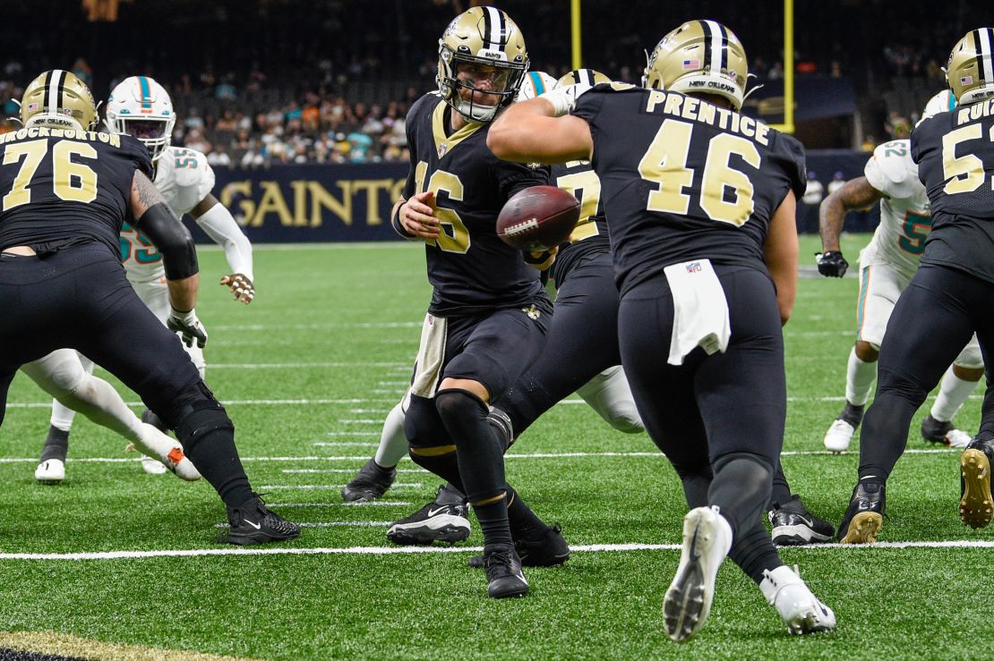 New Orleans Saints quarterback Ian Book (16) hands off to New Orleans Saints fullback Adam Prentice (46) in his own endzone during second half action.