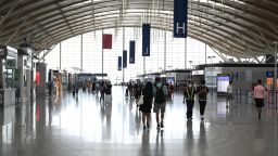 Passengers walk in the departures hall at Shanghai Pudong International Airport on August 23, 2021 in Shanghai.