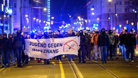Demonstrators march through the city center of the capital of Saxony-Anhalt with a banner that reads "youth against compulsory vaccination" on Monday.
