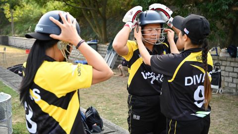 Members of the SCC Divas cricket team get ready for their game against the Hong Kong Cricket Club Cavaliers in Hong Kong on November 8, 2020.
