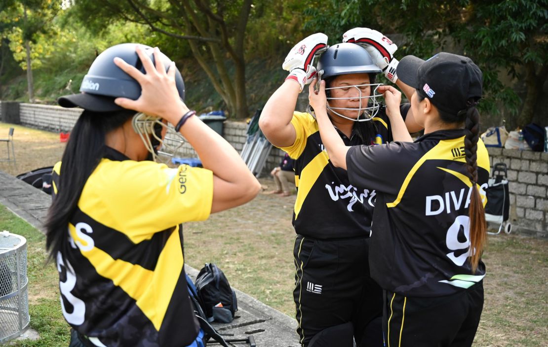 Members of the SCC Divas cricket team get ready for their game against the Hong Kong Cricket Club Cavaliers in Hong Kong on November 8, 2020.
