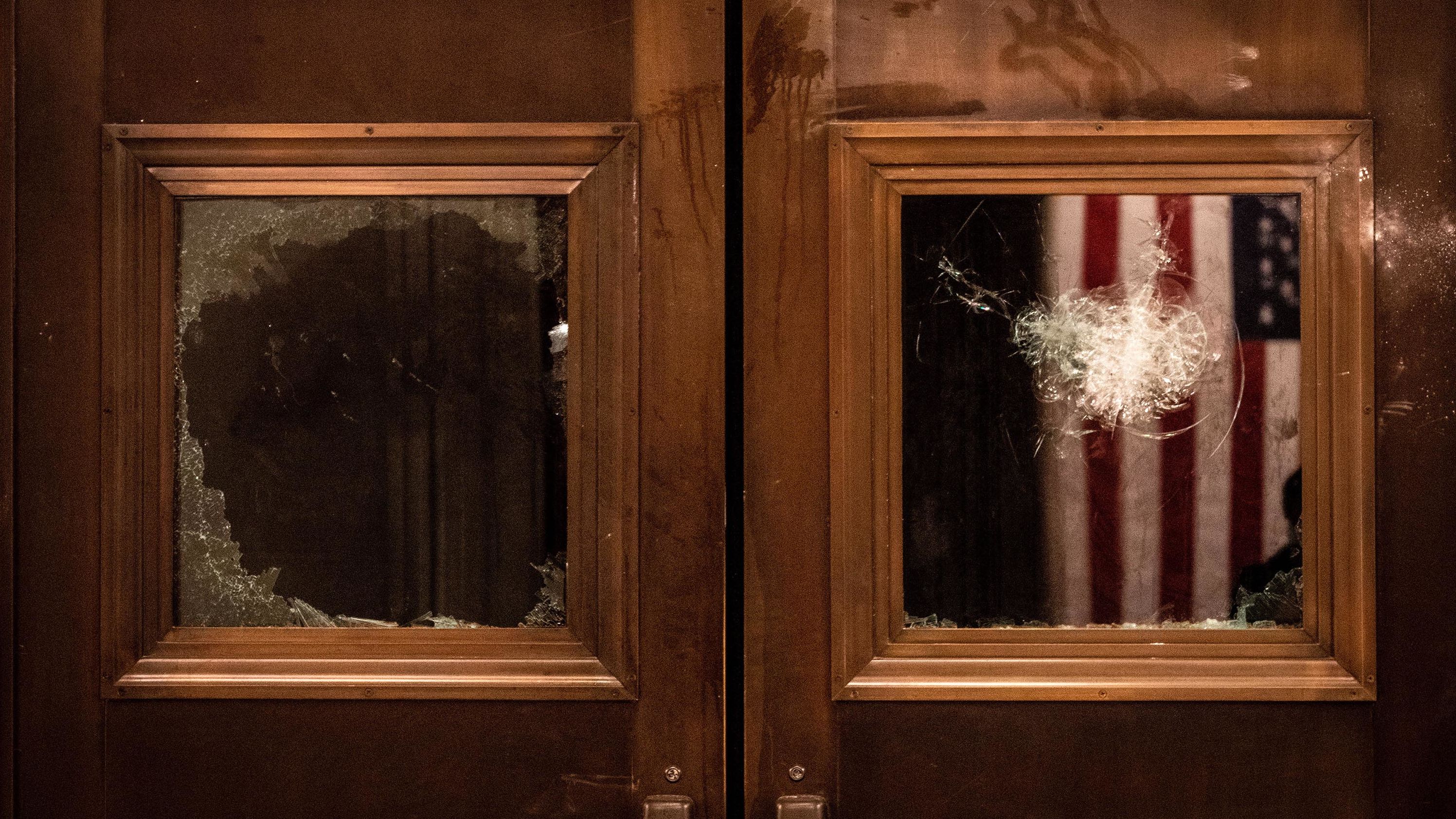 Broken glass is seen on the doors of the Capitol Rotunda entrance.