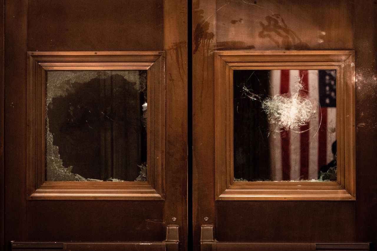 Broken glass is seen on the doors of the Capitol Rotunda entrance.