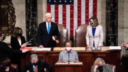 TOPSHOT - Vice President Mike Pence and House Speaker Nancy Pelosi preside over a Joint session of Congress to certify the 2020 Electoral College results after supporters of President Donald Trump stormed the Capitol earlier in the day on Capitol Hill in Washington, DC on January 6, 2021. - Members of Congress returned to the House Chamber after being evacuated when protesters stormed the Capitol and disrupted a joint session to ratify President-elect Joe Biden's 306-232 Electoral College win over President Donald Trump. (Photo by Erin Schaff / POOL / AFP) (Photo by ERIN SCHAFF/POOL/AFP via Getty Images)