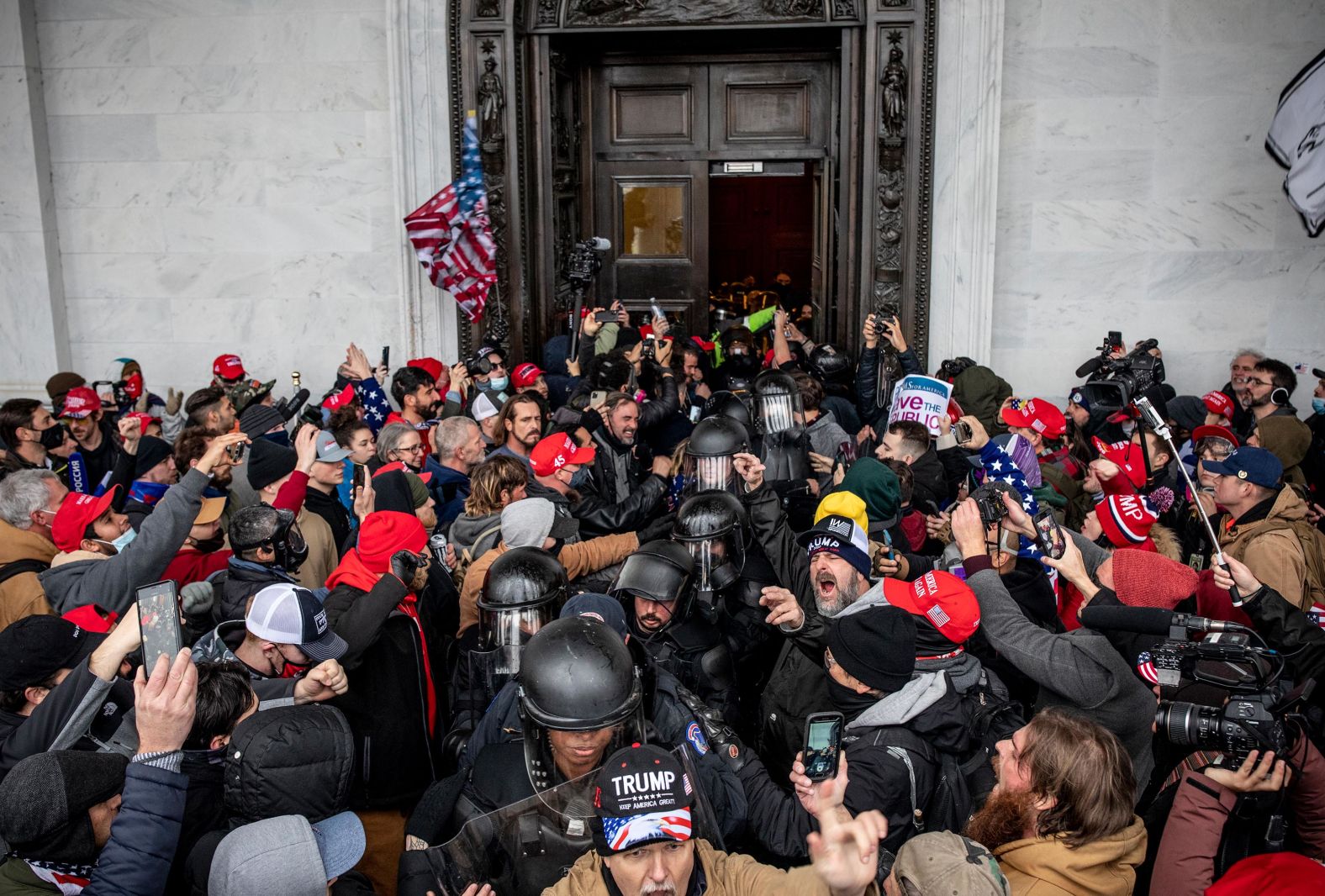 Protesters and police exit the Capitol after the clashes.