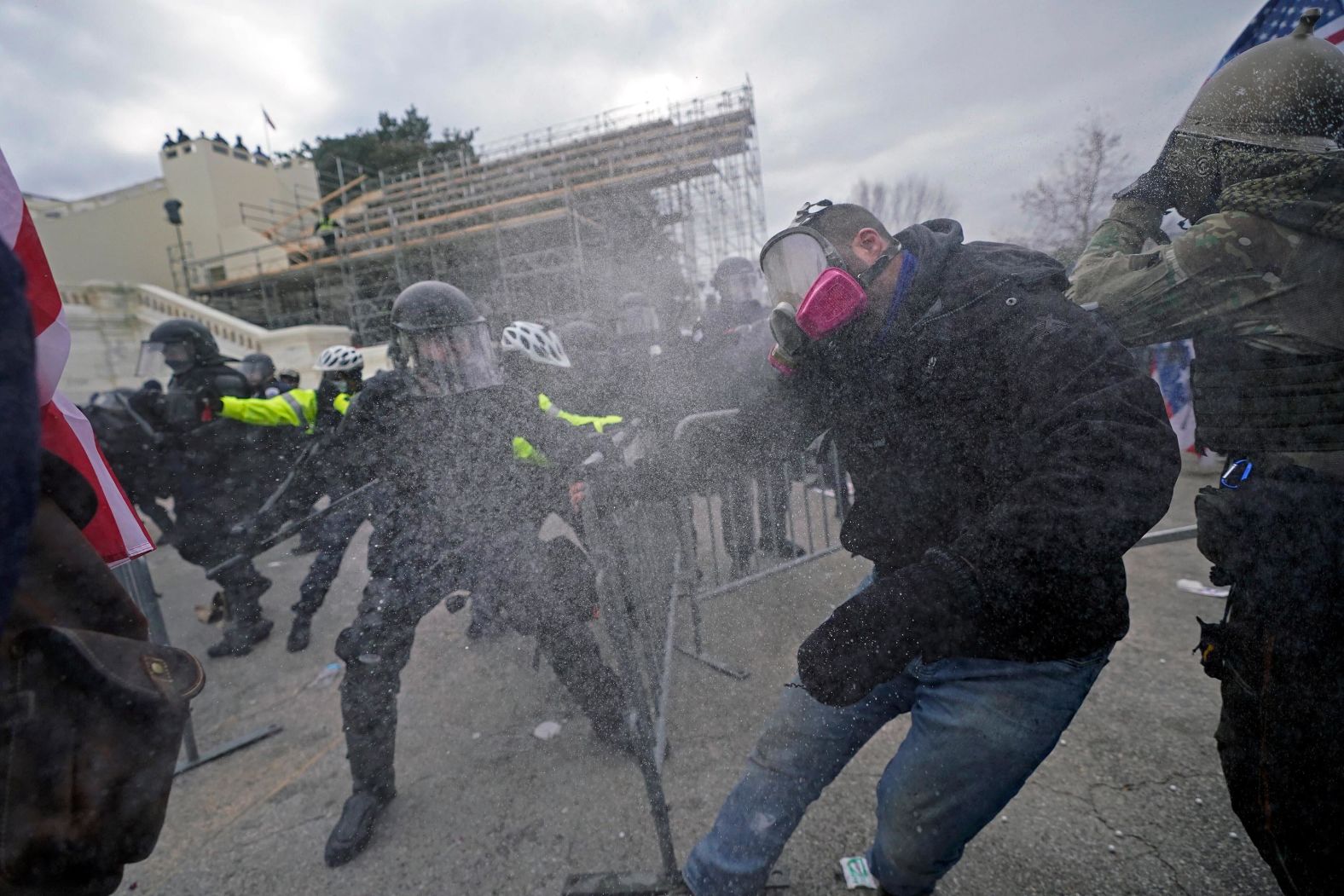 Trump supporters try to break through a police barrier outside the Capitol. Shortly after 1 p.m., some pushed through barriers set up along the perimeter of the Capitol, where they tussled with officers in full riot gear.