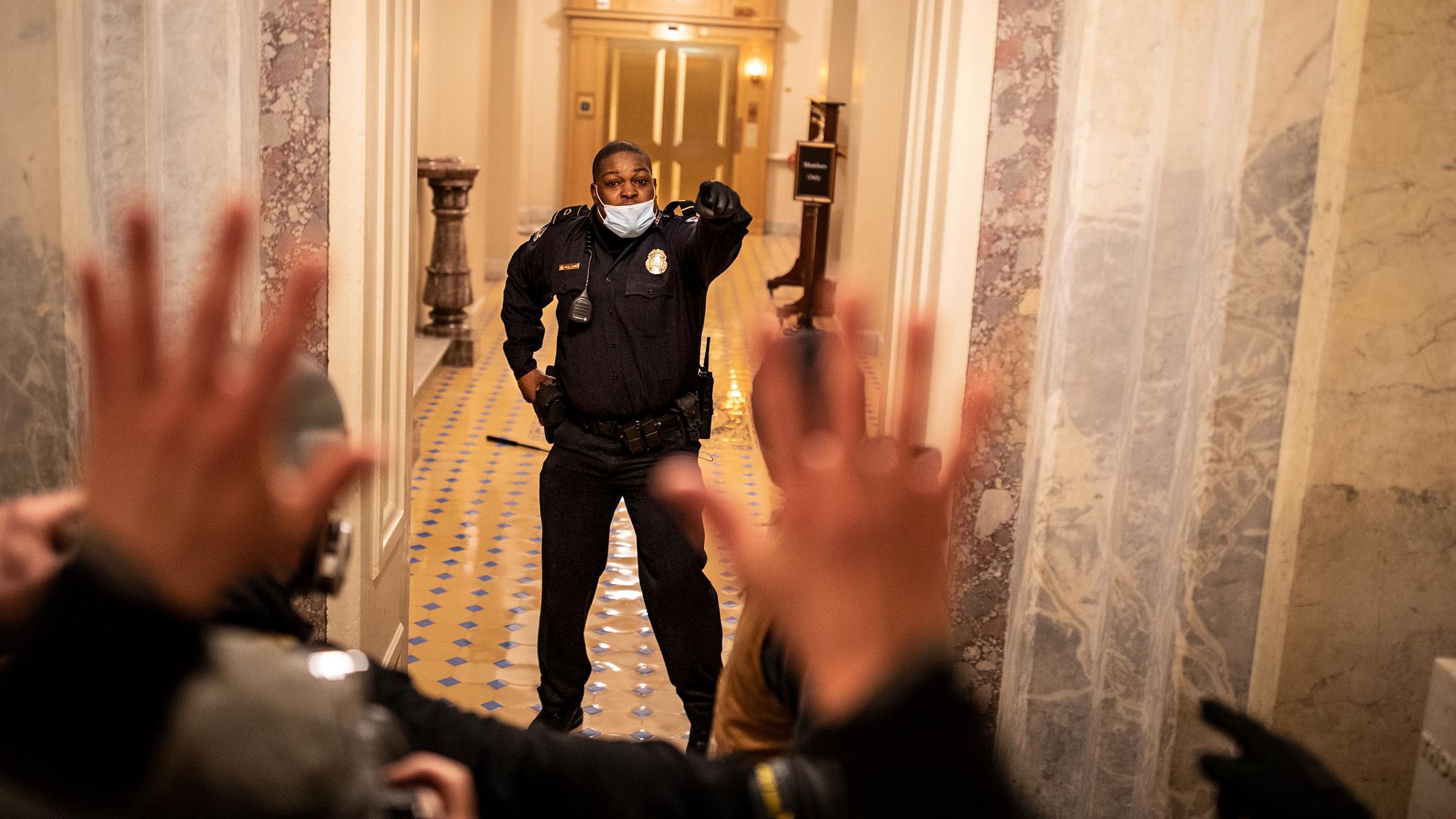 US Capitol Police Officer Eugene Goodman confronts protesters as they storm the building. <a href="https://www.cnn.com/2021/01/07/us/capitol-mob-deaths/index.html" target="_blank">Five people died</a> as a result of the riot, including a woman who was fatally shot by police and three people who died of apparent medical emergencies. Among those who died was <a href="https://www.cnn.com/2021/04/19/politics/brian-sicknick-death-us-capitol-riot/index.html" target="_blank">Officer Brian Sicknick,</a> who suffered strokes and died of natural causes a day after responding to the insurrection.