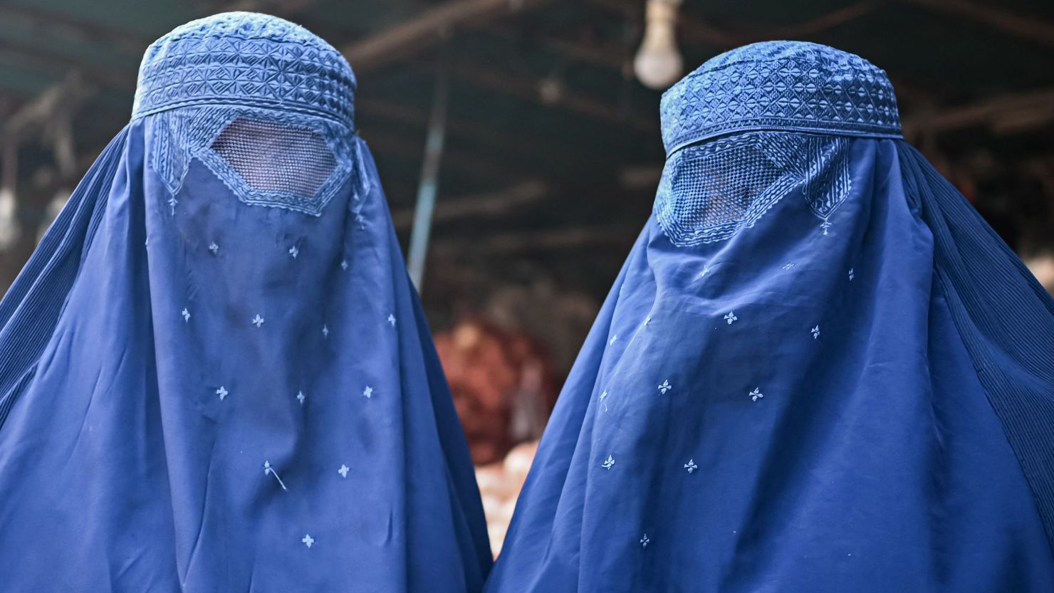 Afghan women are seen at a market in Kabul on December 20, 2021.