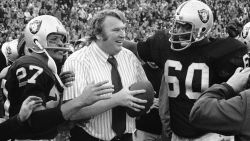 A happy coach John Madden holds the ball which was used to score the winning touchdown against the Miami Dolphins in their playoff game, Dec. 21, 1974 in Oakland. With Madden are Otis Sistrunk (60) and Ron Smith (27). The Raiders won 28-26. (AP Photo)