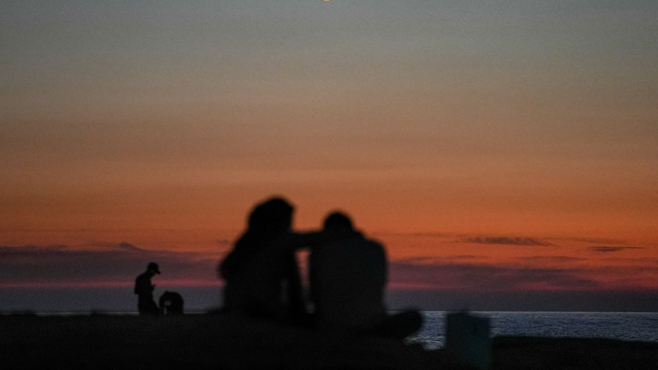 A couple watch the sunset near Beirut's landmark Raouche Sea Rock in November.