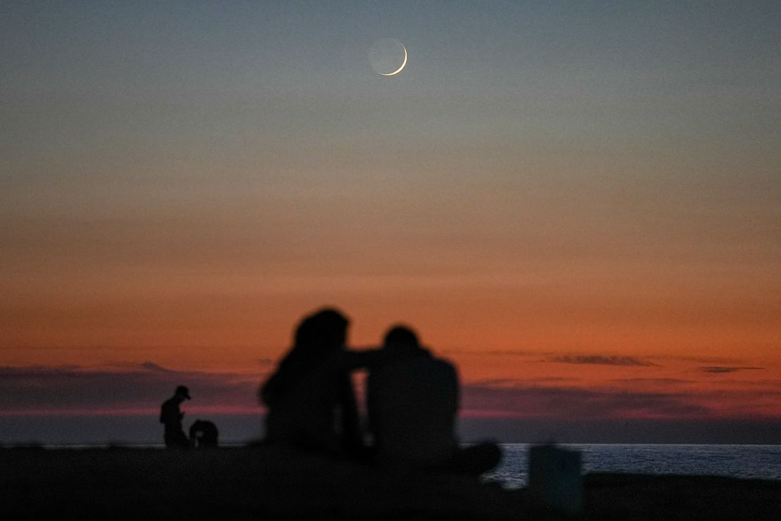 A couple watch the sunset near Beirut's landmark Raouche Sea Rock in November. 