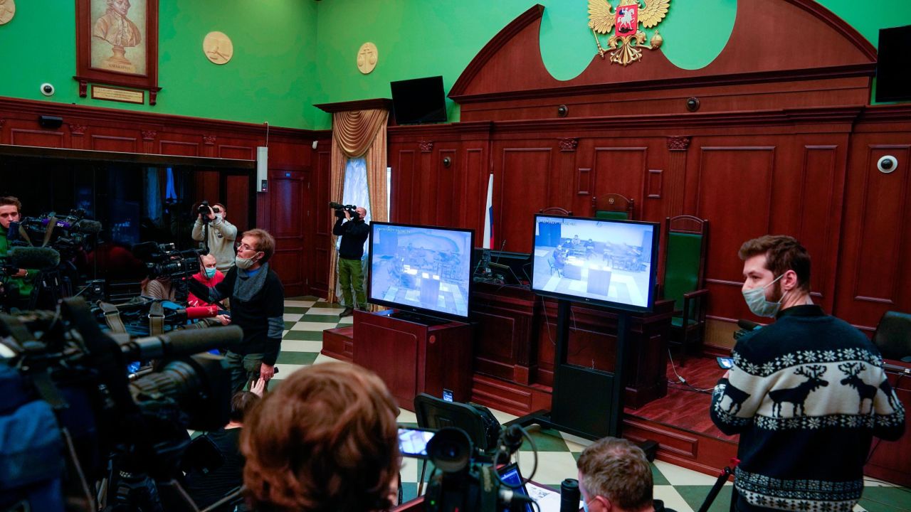 Journalists watch television coverage of Wednesday's hearing.