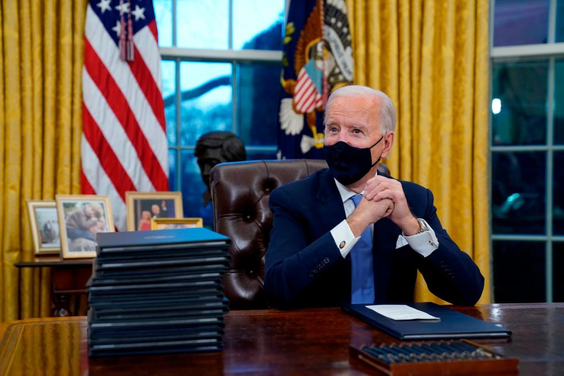 President Joe Biden, masked, in the Oval Office in January. 