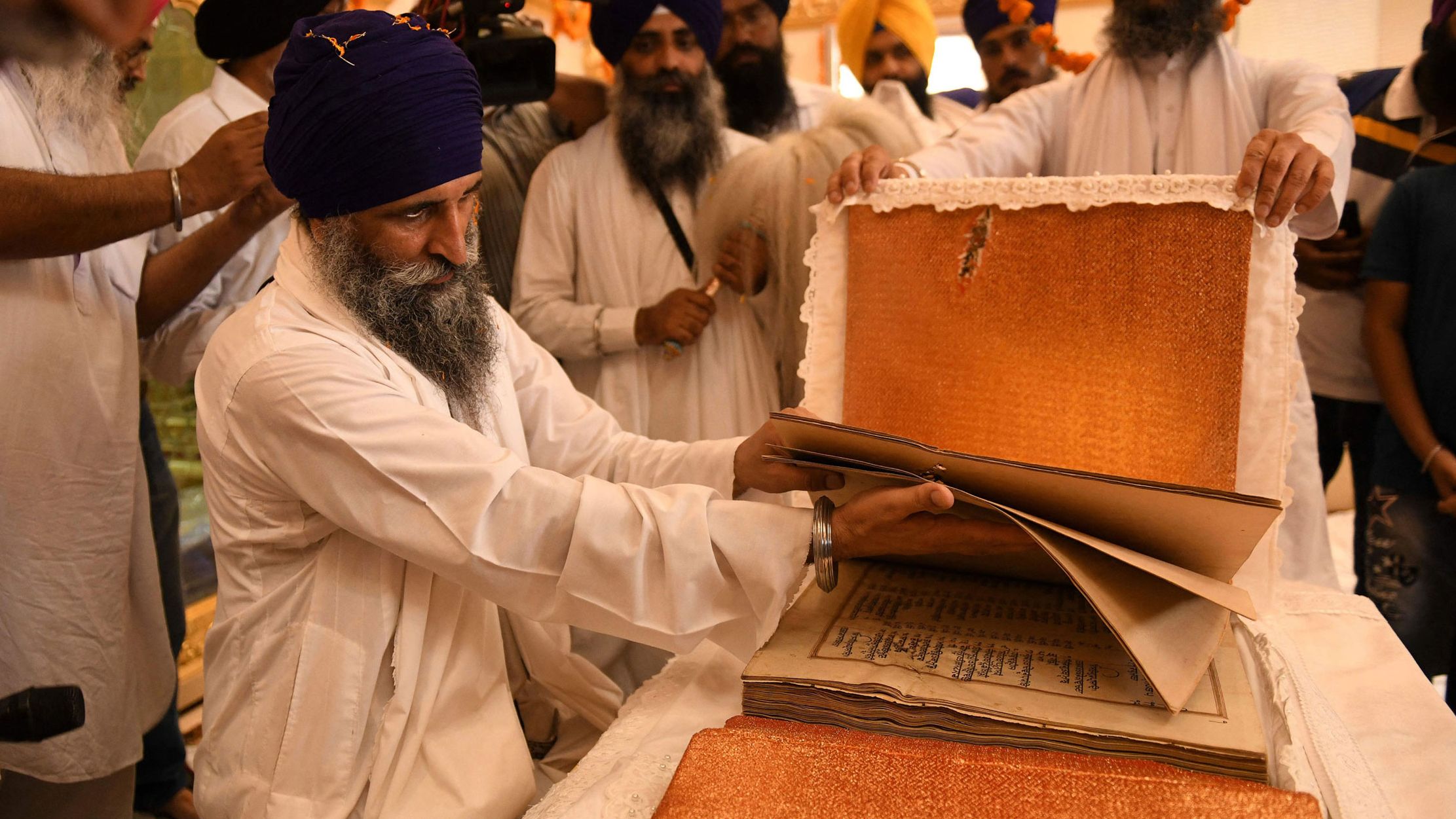 Sikh priest Giani Gurmukh Singh with the Guru Granth Sahib, the Sikh holy book, in the Golden Temple in Amritsar on June 3, 2021. 