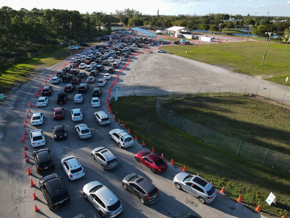Cars wait in long lines at a drive-up Covid-19 testing center Wednesday at Tropical Park in Miami.