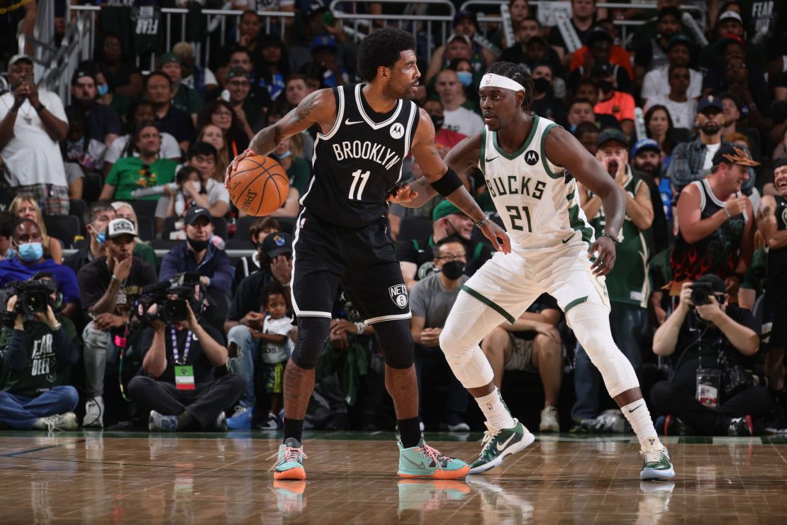 Jrue Holiday #21 of the Milwaukee Bucks plays defense on Kyrie Irving #11 of the Brooklyn Nets during Round 2, Game 4 of the 2021 NBA Playoffs on June 13 2021 at the Fiserv Forum Center in Milwaukee, Wisconsin.
