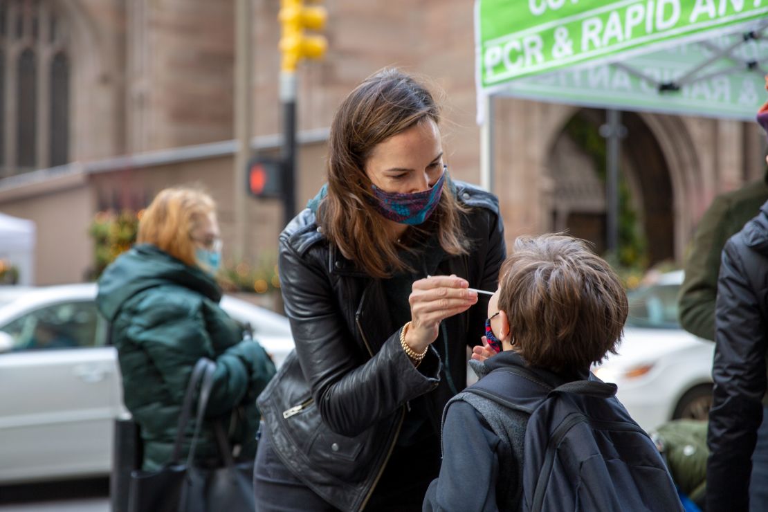 Katie Lucey administers a Covid-19 test to her son Maguire on December 16 in New York.