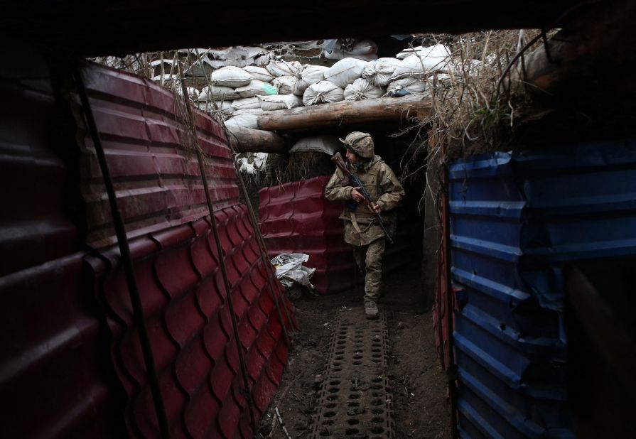 A Ukrainian serviceman walks out of a dugout on the frontline with Russia-backed separatists near the village of Pesky, Donetsk region, on December 14.