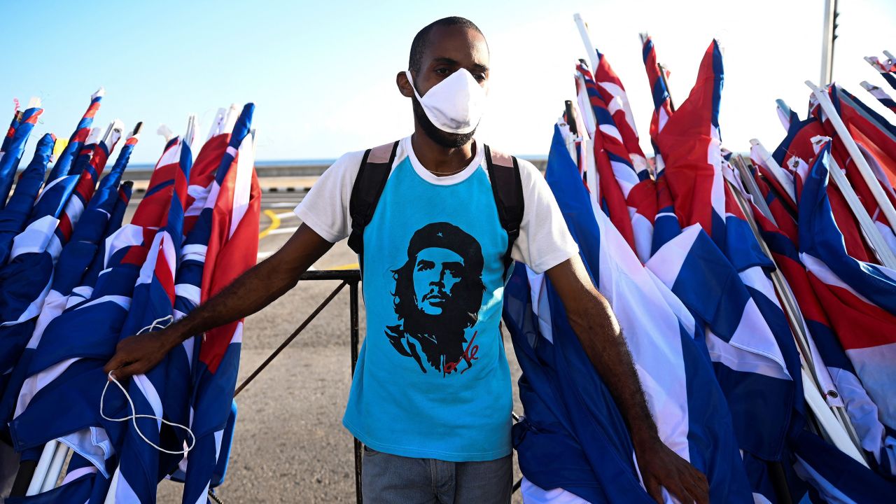 A man is seen with flags during an act of "revolutionary reaffirmation" led by  former Cuban President Raul Castro and his successor, Miguel Diaz-Canel, in Havana, on July 17, 2021, six days after protests shook the country.