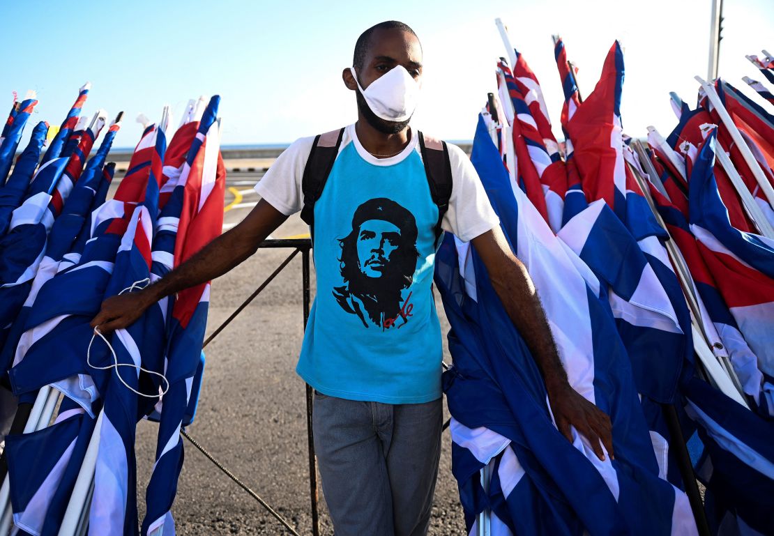A man is seen with flags during an act of "revolutionary reaffirmation" led by  former Cuban President Raul Castro and his successor, Miguel Diaz-Canel, in Havana, on July 17, 2021, six days after protests shook the country.