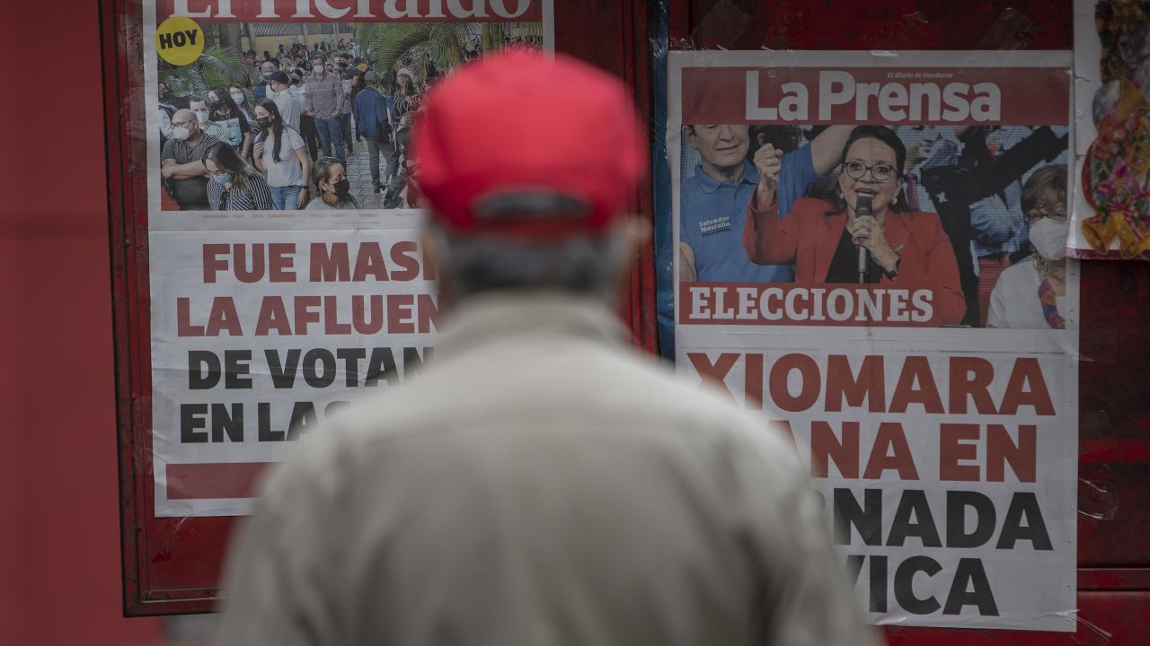 A man reads the covers of local newspapers that announce Xiomara Castro as winner of general elections on November 29, 2021 in Tegucigalpa, Honduras.