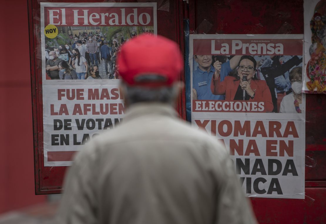 A man reads the covers of local newspapers that announce Xiomara Castro as winner of general elections on November 29, 2021 in Tegucigalpa, Honduras.