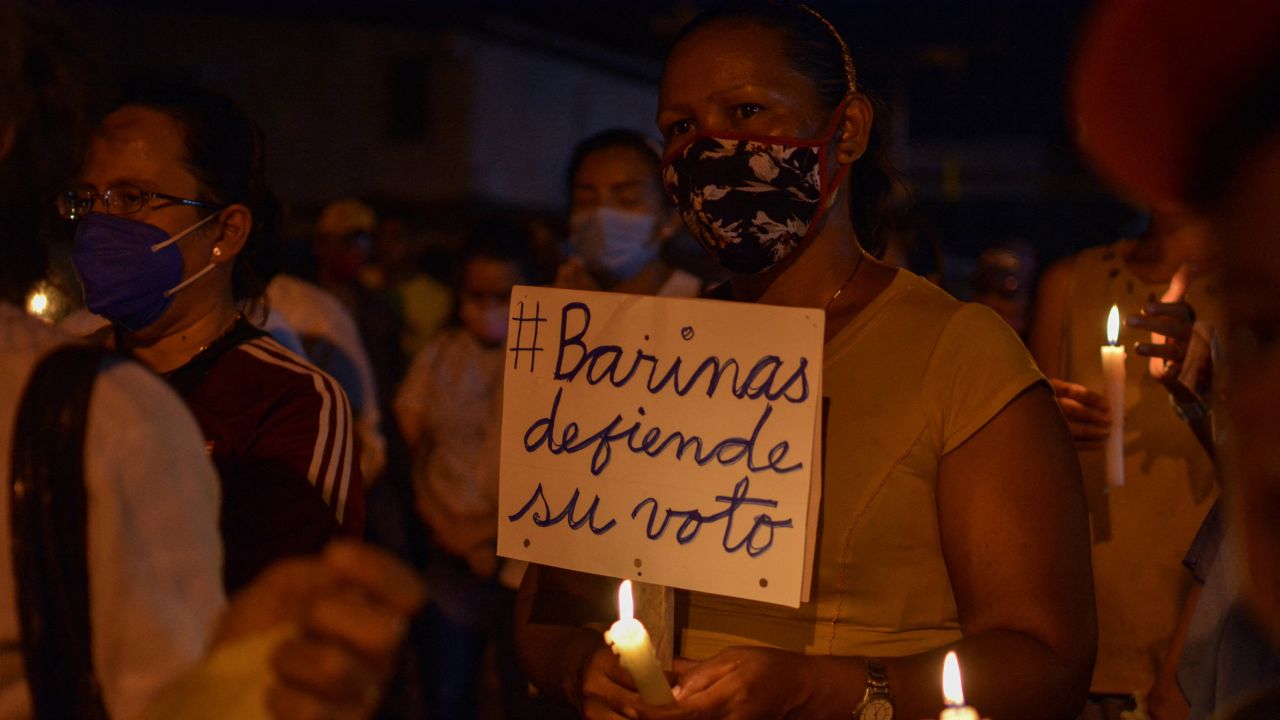 A woman holds a poster reading "Barinas defends its vote" during a demonstration in the city of Barinas, Venezuela, on November 28, 2021.