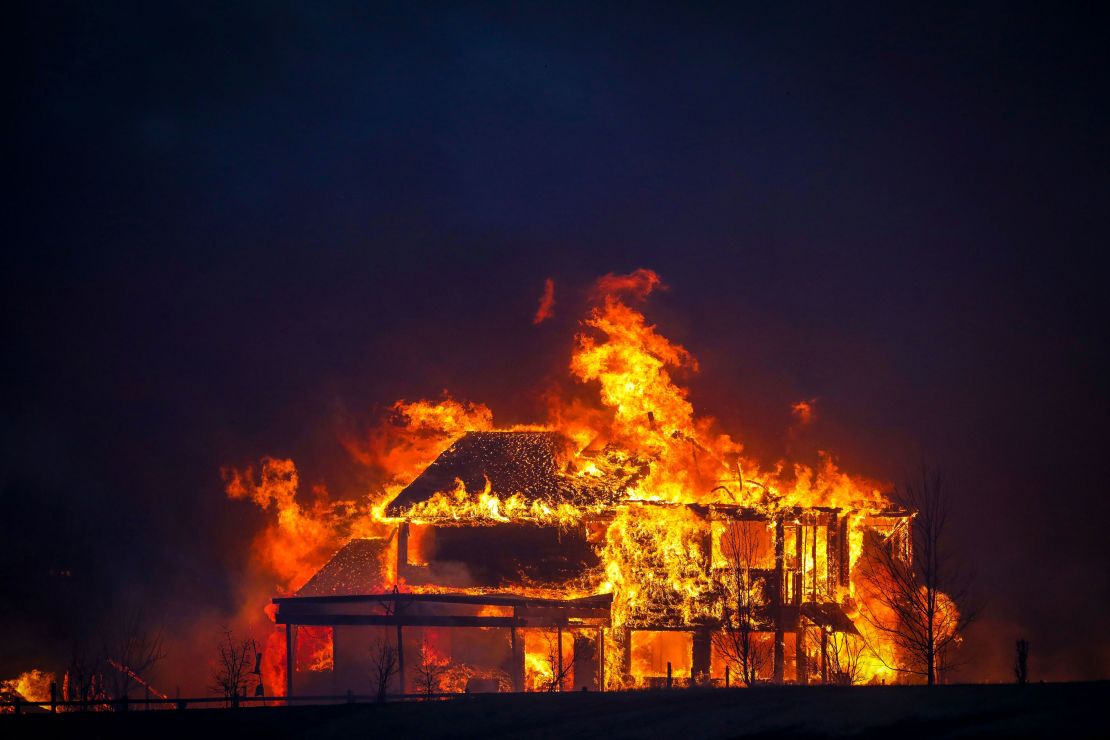 A home burns Thursday after flames swept through the Centennial Heights neighborhood of Louisville.