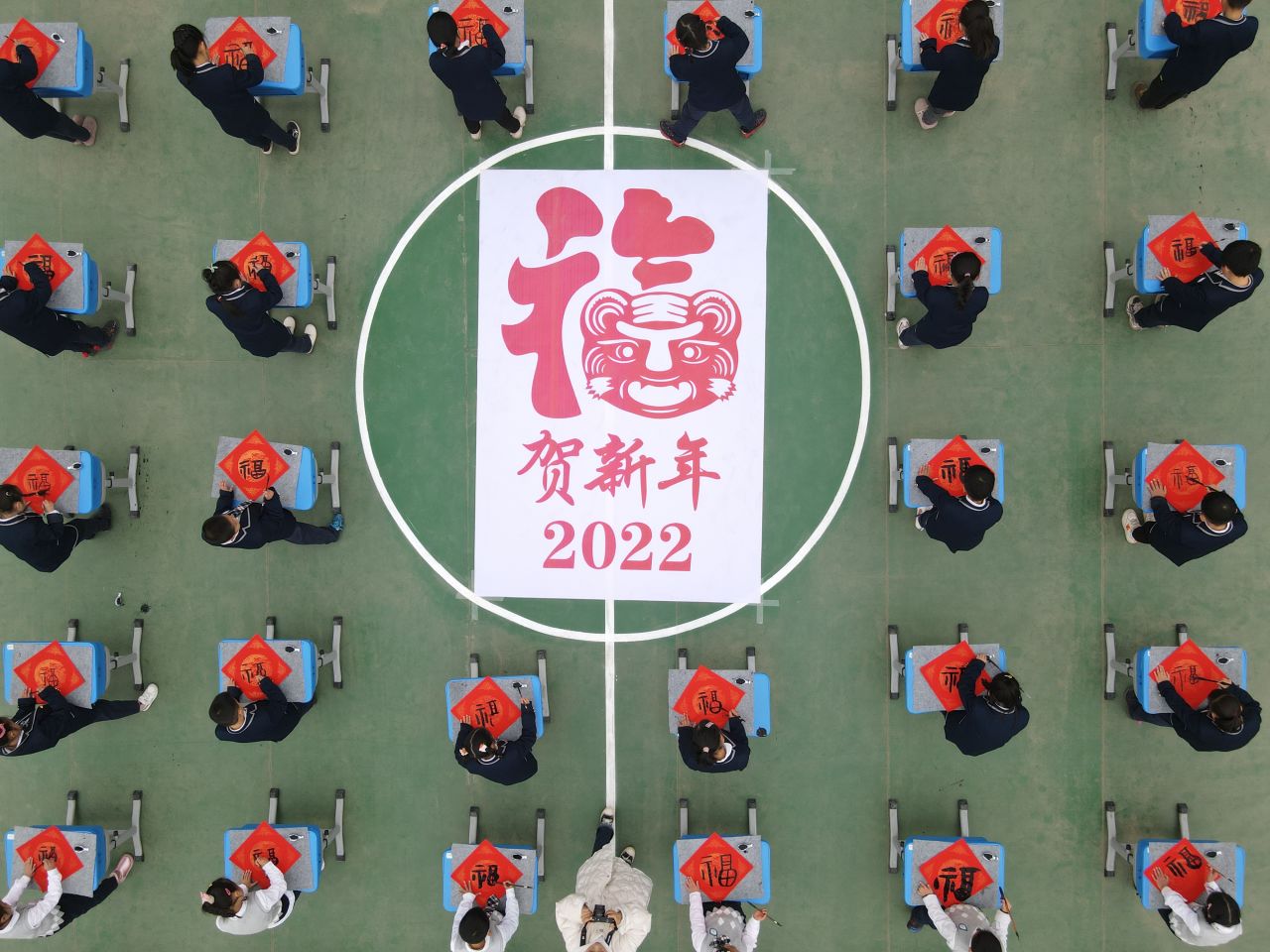 Primary school students in Hefei, China, celebrate the new year by writing the character "fu," which means "good luck."