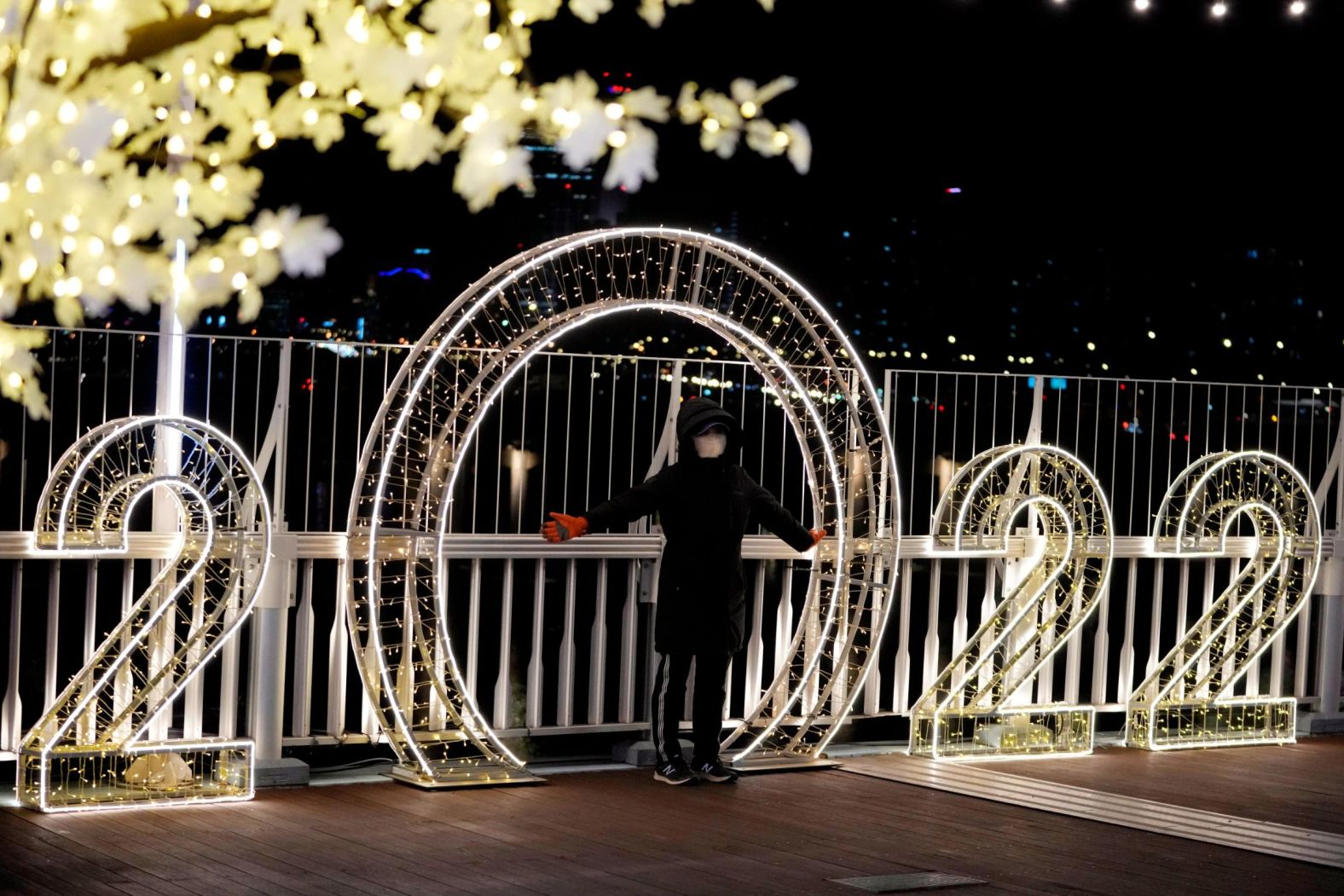 A visitor poses in front of a 2022 decoration in Seoul, South Korea.