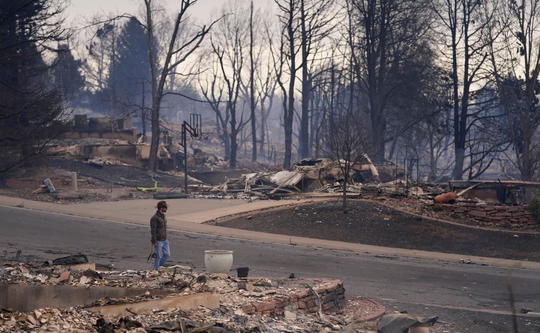 A man walks through the devastated area of Louisville, Colorado, on December 31, 2021, after a wildfire tore through the area. 