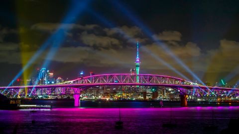 A light show from the Skytower and harbour bridge during New Year's Eve celebrations in Auckland, New Zealand, on January 1, 2022.