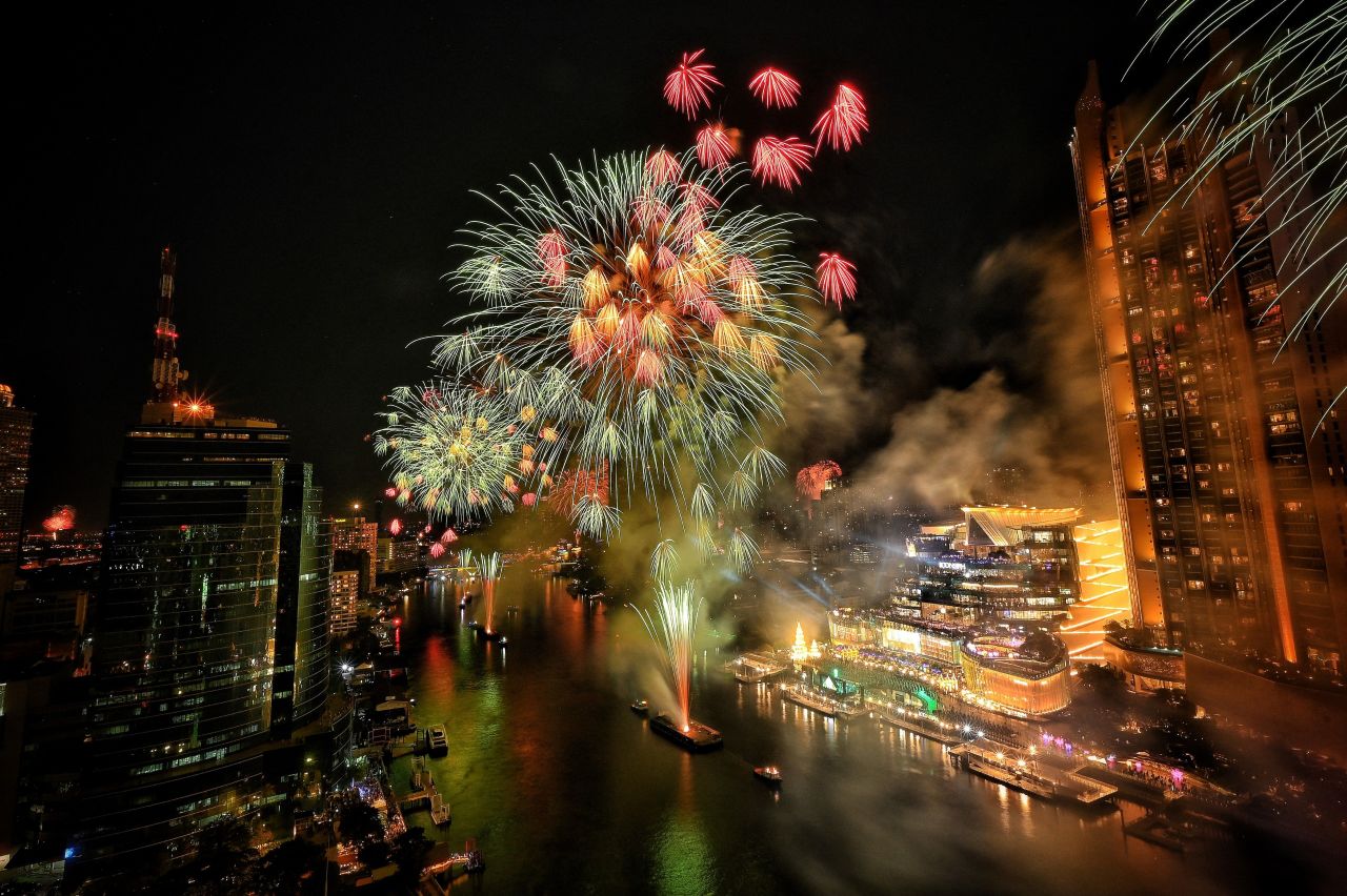 Fireworks erupt over the Chao Phraya River in Bangkok, Thailand.