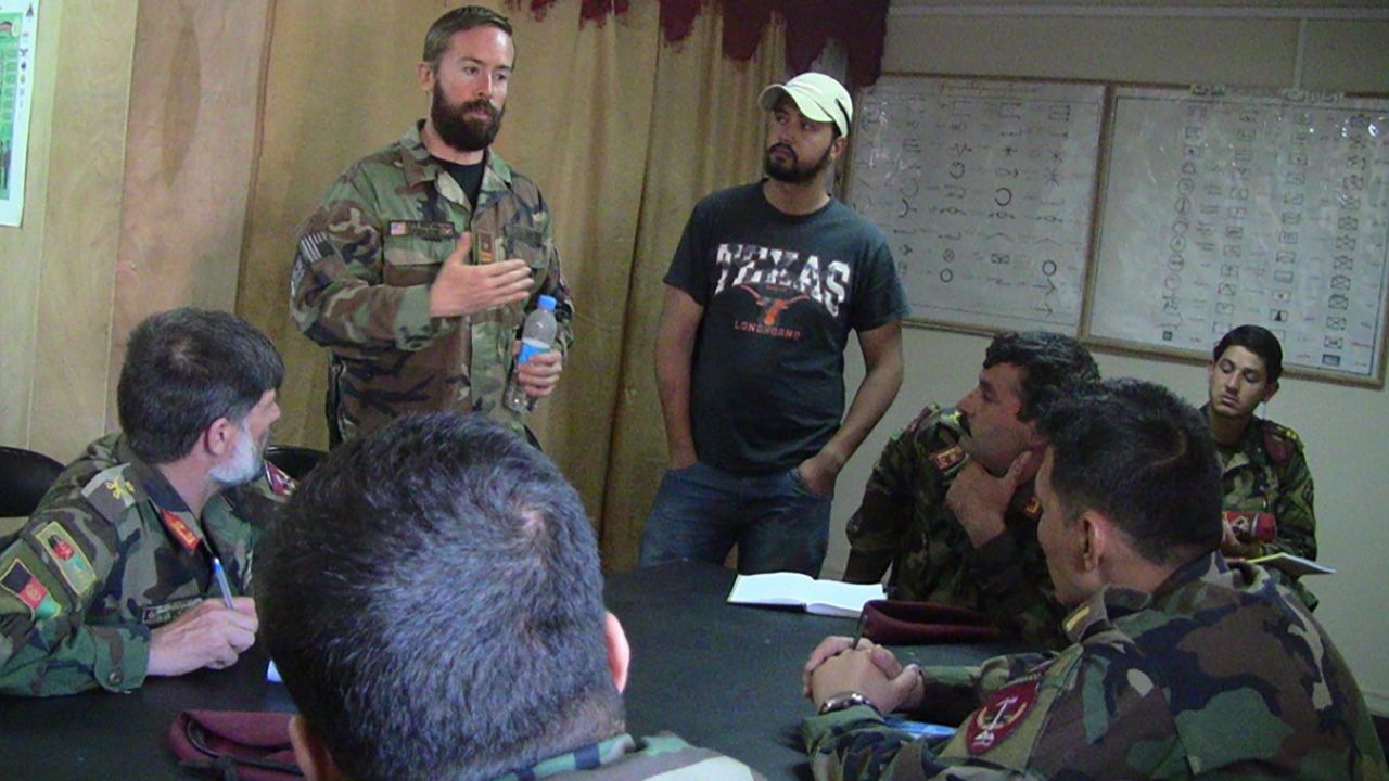 Drew Horn (left, standing) speaks with members of the Afghan military.