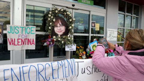 A woman stands at a memorial for Valentina Orellana-Peralta at the door of the Burlington where she was killed, in North Hollywood, California, on December 28.
