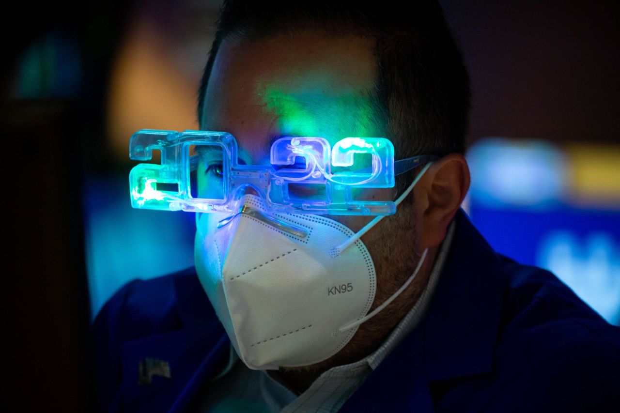 A trader wears 2022 glasses while working on the floor of the New York Stock Exchange.