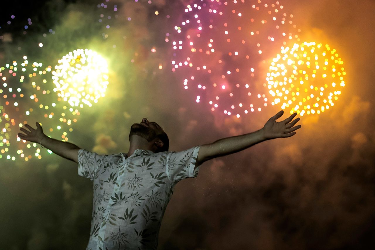 A man celebrates the start of the new year on Copacabana Beach in Rio de Janeiro, Brazil.