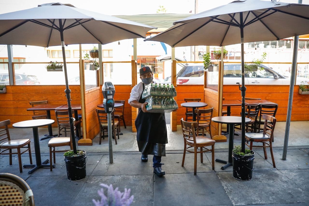 Angel Garcia carries Perrier into Cole Valley restaurant Zazie in San Francisco, California, on October 13.