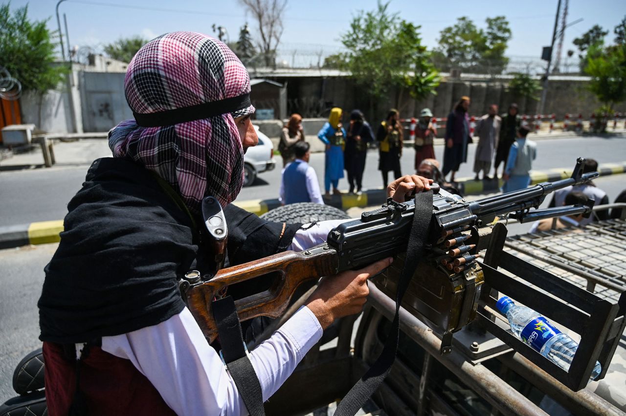 A Taliban fighter mans a machine gun on top of a vehicle as they patrol along a street in Kabul on Monday, August 16.