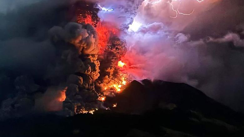 This handout photograph taken and released by the Center for Volcanology and Geological Hazard Mitigation on April 17, 2024 shows Mount Ruang spewing hot lava and smoke as seen from Sitaro, North Sulawesi. A volcano erupted several times in Indonesia's outermost region overnight on April 17, forcing hundreds of people to be evacuated after it spewed lava and a column of smoke more than a mile into the sky. (Photo by Center for Volcanology and Geological Hazard Mitigation / AFP) / RESTRICTED TO EDITORIAL USE - MANDATORY CREDIT AFP PHOTO / CENTER FOR VOLCANOLOGY AND GEOLOGICAL HAZARD MITIGATION/ PVMBK - NO MARKETING - NO ADVERTISING CAMPAIGNS- DISTRIBUTED AS A SERVICE TO CLIENTS (Photo by -/Center for Volcanology and Geological Hazard Mitigation/AFP via Getty Images)