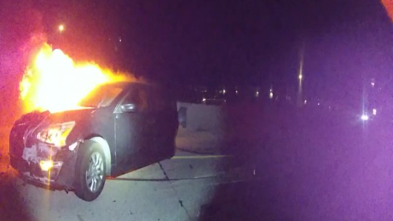 ‘Get out! Get out!’: Officer tries to free woman from vehicle engulfed in flames