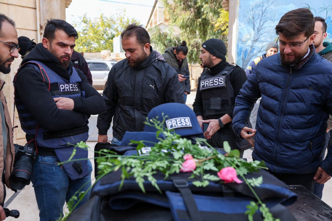 Mourners and colleagues surround the body Syrian photojournalist Anas Alkharboutli, during his funeral in Syria's northern city of Idlib on December 4, 2024.