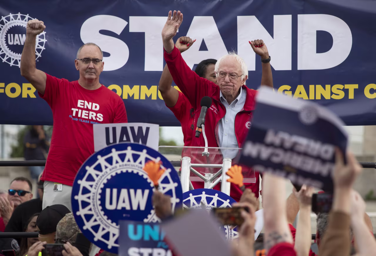 Bernie Sanders and UAW President Shawn Fain, left, speak at a rally in support of United Auto Workers members as they strike in Detroit, Michigan, on September 15.