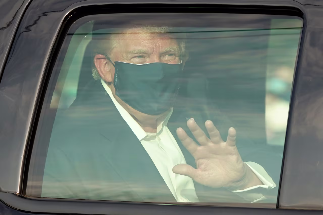 President Donald Trump waves to supporters outside of Walter Reed Medical Center in Bethesda, Maryland, on October 4. 
