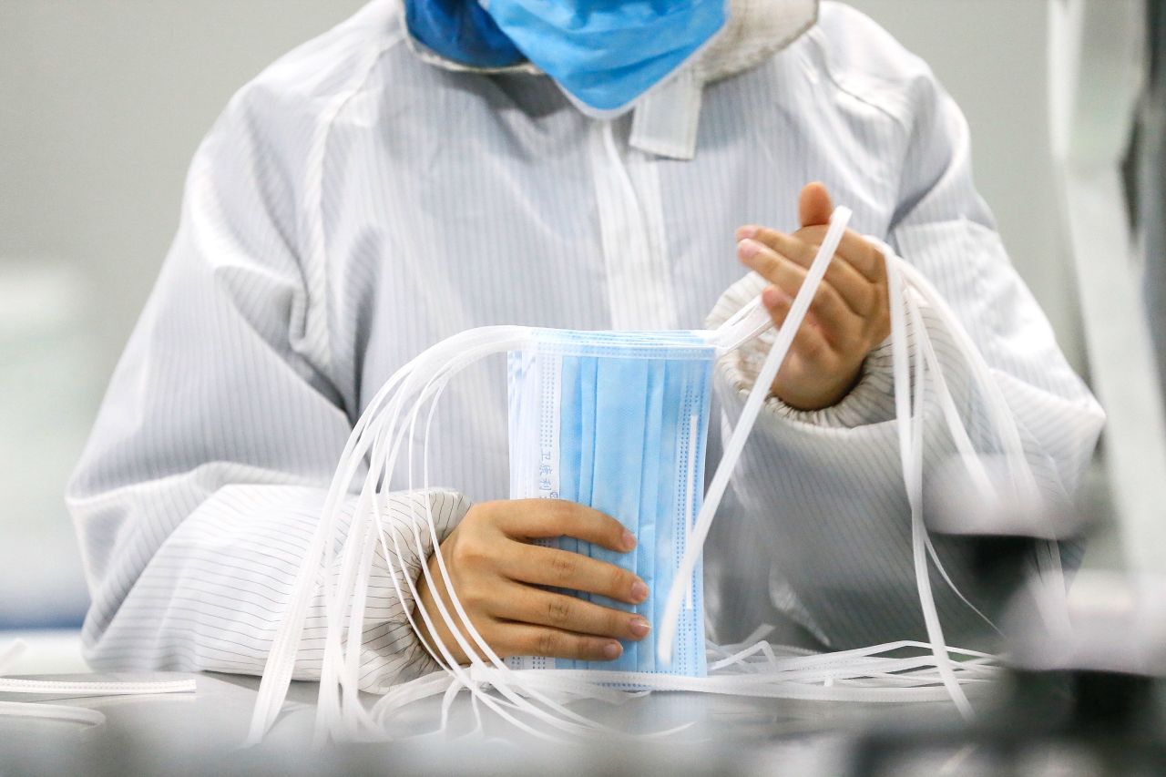 A worker produces protective face masks at a factory in Qingdao in China's eastern Shandong province.