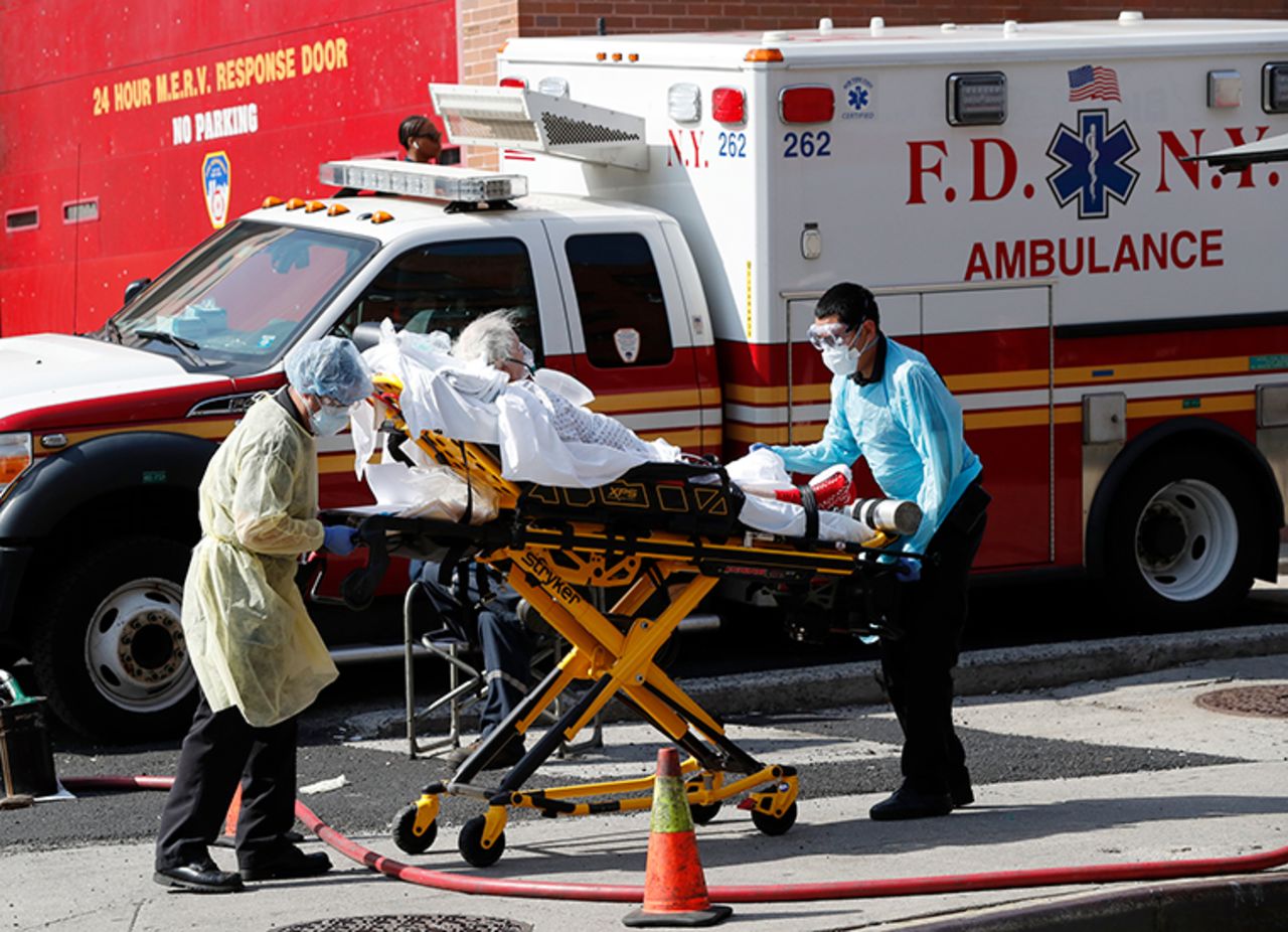 A patient is transferred from Elmhurst Hospital Center to a waiting ambulance during the coronavirus outbreak, Tuesday, April 7, in New York. 